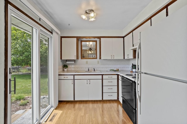 13304 E Desmet Ave, Spokane Valley, WA 99216 - kitchen featuring freestanding refrigerator, range with electric stovetop, light countertops, and plenty of natural light