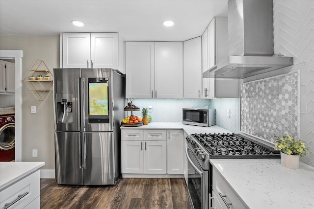 903 E 11th Ave, Spokane, WA 99202 - kitchen with stainless steel appliances, wall chimney exhaust hood, dark wood finished floors, white cabinets, and recessed lighting