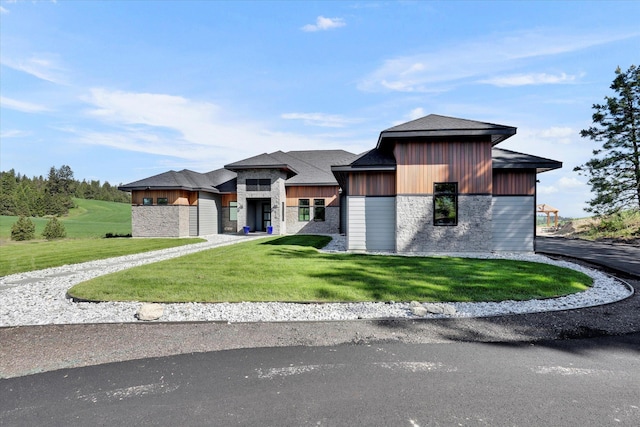 5110 W Hayden Ln, Spokane, WA 99208 - view of front of home with stone siding, a front yard, and driveway