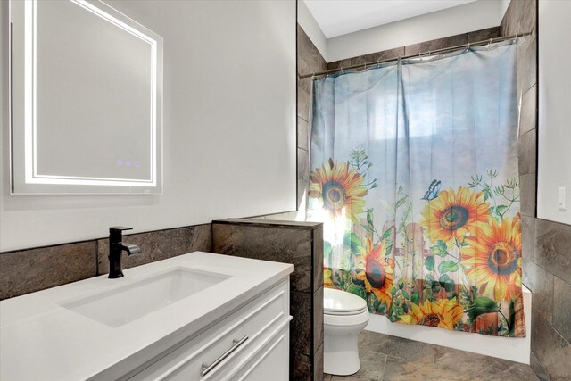 5110 W Hayden Ln, Spokane, WA 99208 - full bathroom with toilet, vanity, tile walls, and shower / bath combination with curtain