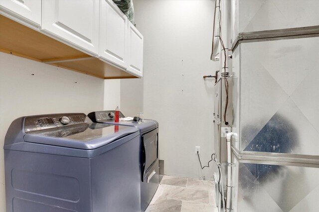 5110 W Hayden Ln, Spokane, WA 99208 - laundry area featuring washer and clothes dryer and cabinet space