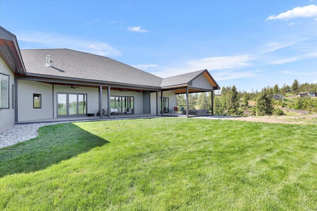 5110 W Hayden Ln, Spokane, WA 99208 - back of property featuring ceiling fan, a yard, a patio area, and a shingled roof