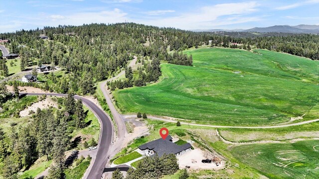 5110 W Hayden Ln, Spokane, WA 99208 - aerial view of property's location featuring a heavily wooded area, a mountainous background, and a golf course