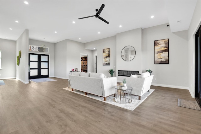 5110 W Hayden Ln, Spokane, WA 99208 - living room with ceiling fan, recessed lighting, wood finished floors, baseboards, and a glass covered fireplace