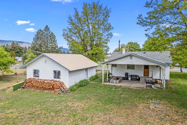 705 Old Kettle Rd, Kettle Falls, WA 99114 - back of house with a lawn and a patio