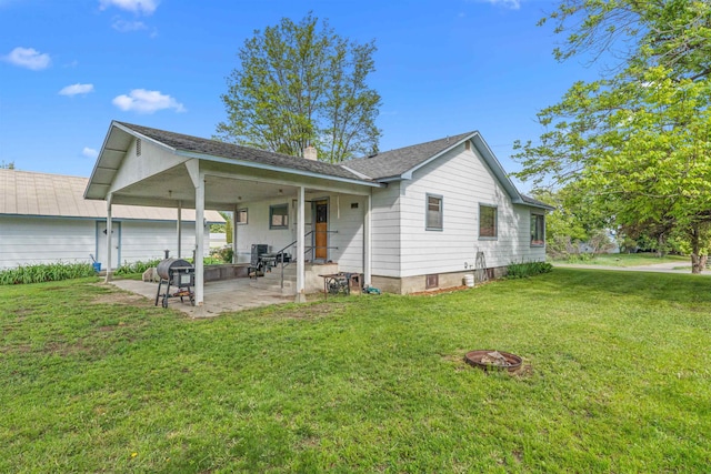 705 Old Kettle Rd, Kettle Falls, WA 99114 - back of house with a patio area, a yard, and a chimney