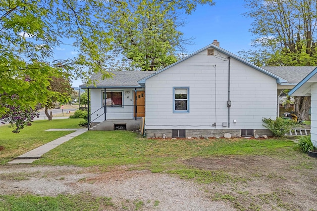705 Old Kettle Rd, Kettle Falls, WA 99114 - rear view of property with a chimney, a lawn, and roof with shingles