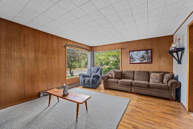 705 Old Kettle Rd, Kettle Falls, WA 99114 - living area featuring wood walls, wood finished floors, and a baseboard heating unit
