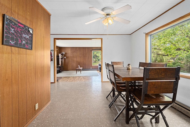705 Old Kettle Rd, Kettle Falls, WA 99114 - dining room featuring tile patterned floors, a ceiling fan, and wooden walls