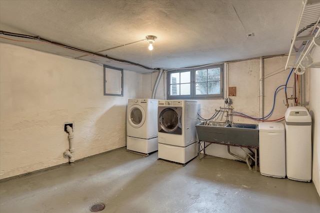 112 E 22nd Ave, Spokane, WA 99203 - below grade area with separate washer and dryer, a textured wall, a textured ceiling, a sink, and a water softener