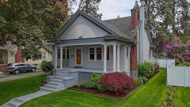 112 E 22nd Ave, Spokane, WA 99203 - bungalow-style home featuring covered porch and a chimney