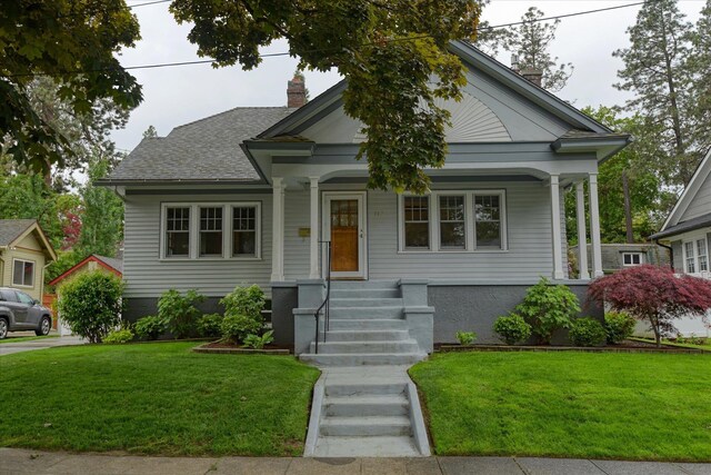 112 E 22nd Ave, Spokane, WA 99203 - view of front facade with a chimney, covered porch, and a front yard