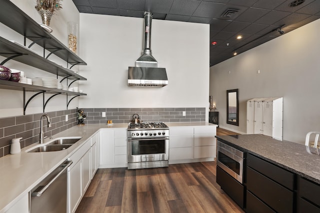 423 W 1st Ave Unit 110, Spokane, WA 99201 - kitchen with stainless steel appliances, open shelves, a sink, range hood, and white cabinets