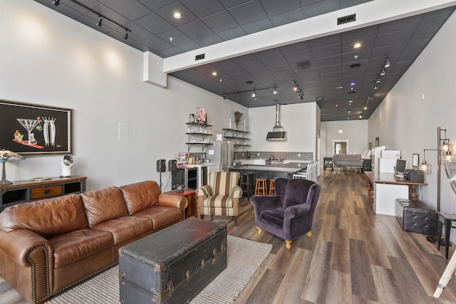 423 W 1st Ave Unit 110, Spokane, WA 99201 - living room featuring wood finished floors, rail lighting, and a paneled ceiling