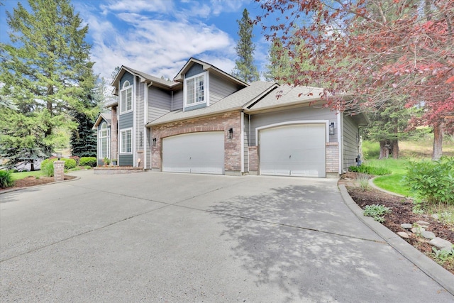 16906 N Golden Dr, Colbert, WA 99005 - view of front of house featuring driveway, a garage, brick siding, and a shingled roof