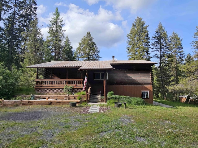 2267 Hawks Rd, Colville, WA 99114 - log cabin featuring log siding, metal roof, and a front lawn
