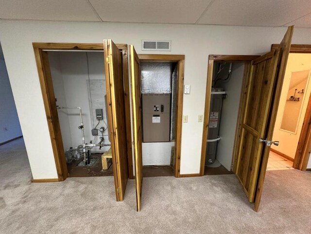 2267 Hawks Rd, Colville, WA 99114 - bedroom with light carpet, water heater, a closet, and baseboards