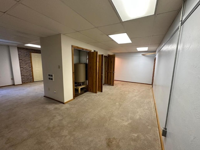 2267 Hawks Rd, Colville, WA 99114 - finished below grade area with a paneled ceiling, light carpet, gas water heater, and baseboards