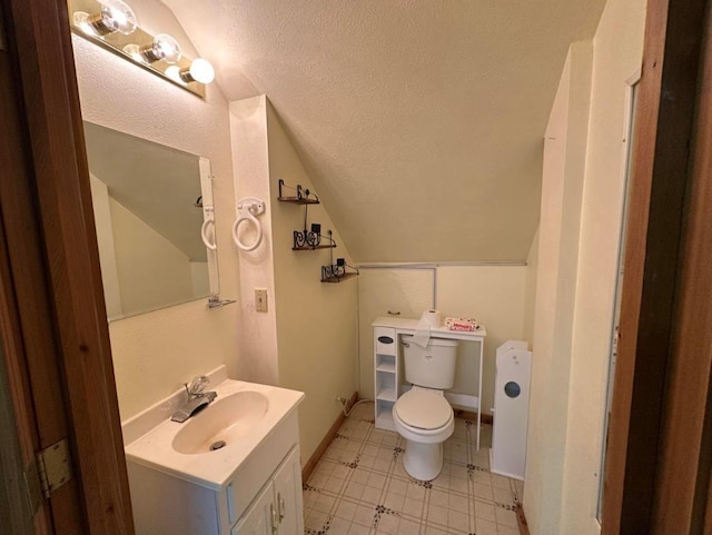 2267 Hawks Rd, Colville, WA 99114 - half bath featuring toilet, vaulted ceiling, vanity, tile patterned floors, and a textured ceiling