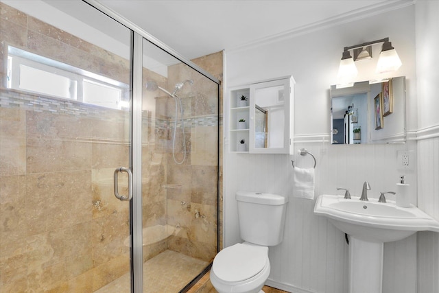 7311 E Fairview Ave, Spokane Valley, WA 99212 - bathroom featuring toilet, a stall shower, a wainscoted wall, and ornamental molding