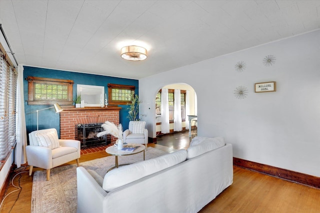 7311 E Fairview Ave, Spokane Valley, WA 99212 - living area with arched walkways, baseboards, wood finished floors, and a fireplace