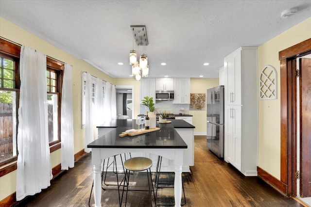 7311 E Fairview Ave, Spokane Valley, WA 99212 - kitchen with stainless steel appliances, dark countertops, white cabinets, and recessed lighting