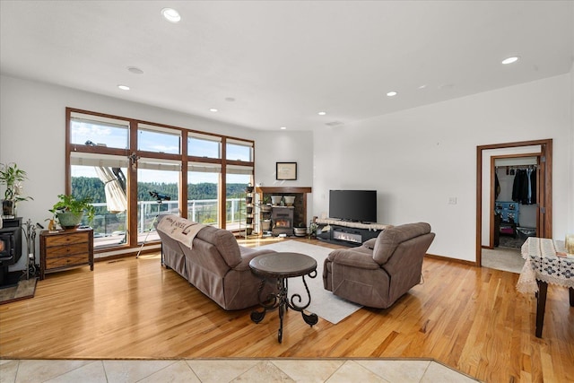 16503 W Bluebird Ln, Spokane, WA 99224 - living room featuring a wood stove, recessed lighting, and light tile patterned floors