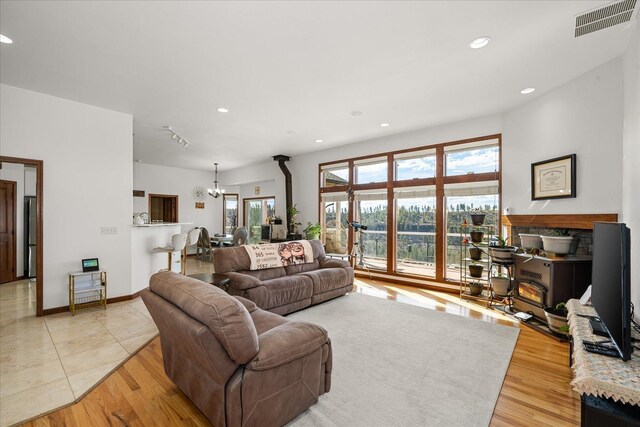 16503 W Bluebird Ln, Spokane, WA 99224 - living room with a chandelier, recessed lighting, light wood-style flooring, and baseboards