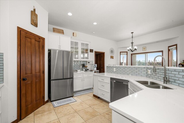16503 W Bluebird Ln, Spokane, WA 99224 - kitchen with appliances with stainless steel finishes, a sink, tasteful backsplash, light countertops, and recessed lighting