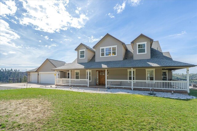 16503 W Bluebird Ln, Spokane, WA 99224 - farmhouse-style home with a porch, a front yard, concrete driveway, and a shingled roof