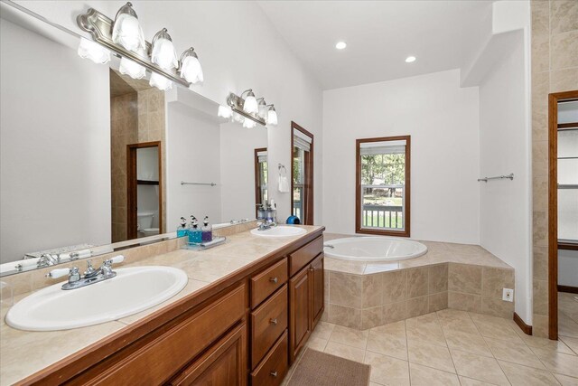 16503 W Bluebird Ln, Spokane, WA 99224 - bathroom with a bath, tile patterned flooring, double vanity, and recessed lighting