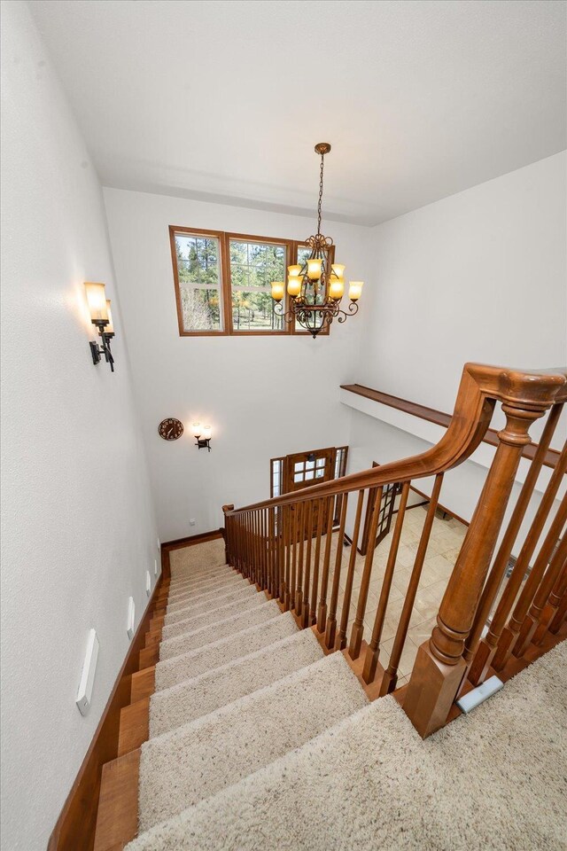 16503 W Bluebird Ln, Spokane, WA 99224 - staircase with a chandelier and baseboards