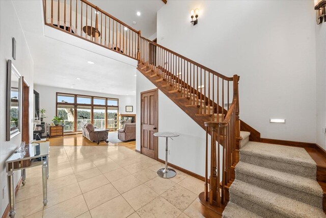 16503 W Bluebird Ln, Spokane, WA 99224 - stairs with a towering ceiling, baseboards, recessed lighting, and tile patterned flooring