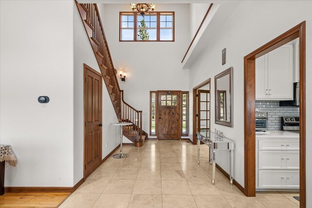 16503 W Bluebird Ln, Spokane, WA 99224 - foyer with stairway, healthy amount of natural light, baseboards, and a high ceiling