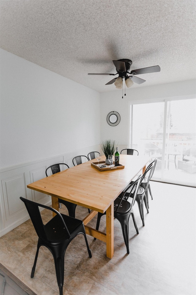 423 W Providence Ave, Spokane, WA 99205 - dining space featuring a ceiling fan, a textured ceiling, and wainscoting