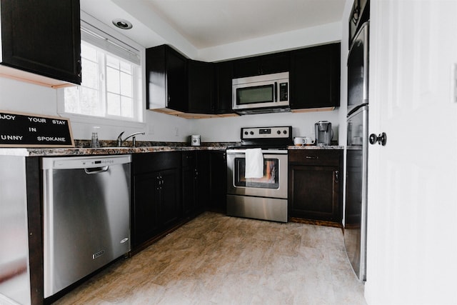 423 W Providence Ave, Spokane, WA 99205 - kitchen featuring appliances with stainless steel finishes, dark cabinetry, and a sink
