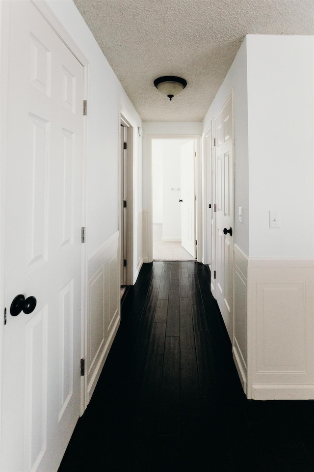 423 W Providence Ave, Spokane, WA 99205 - hall with a wainscoted wall, a textured ceiling, and dark wood-type flooring