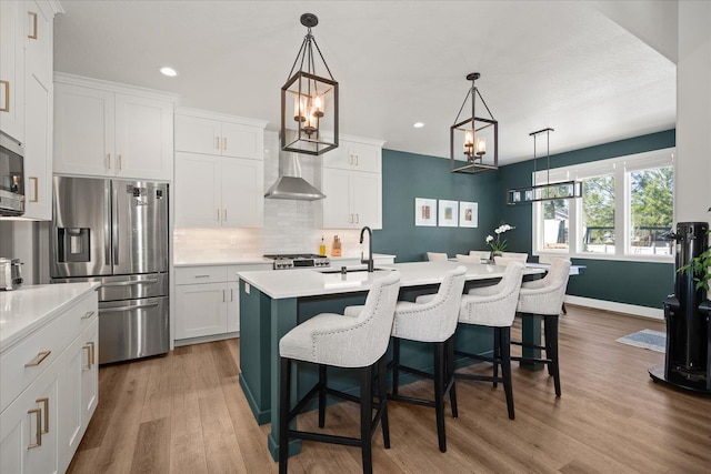 5212 W Decatur Ave, Spokane, WA 99208 - kitchen featuring appliances with stainless steel finishes, recessed lighting, light countertops, wood finished floors, and tasteful backsplash