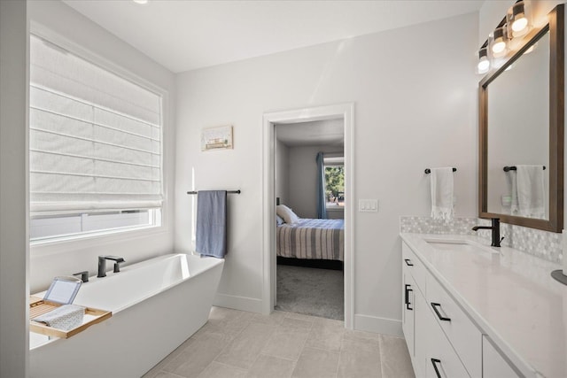 5212 W Decatur Ave, Spokane, WA 99208 - ensuite bathroom with vanity, a freestanding bath, baseboards, and tasteful backsplash