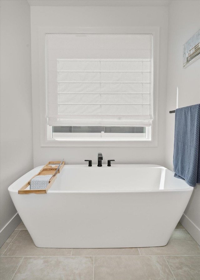 5212 W Decatur Ave, Spokane, WA 99208 - bathroom with a freestanding bath, baseboards, and tile patterned floors