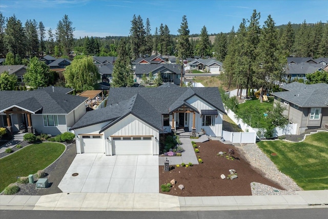 5212 W Decatur Ave, Spokane, WA 99208 - view of front of property with board and batten siding, a garage, a residential view, driveway, and roof with shingles