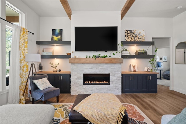 5212 W Decatur Ave, Spokane, WA 99208 - living room with beam ceiling, wood finished floors, and a stone fireplace