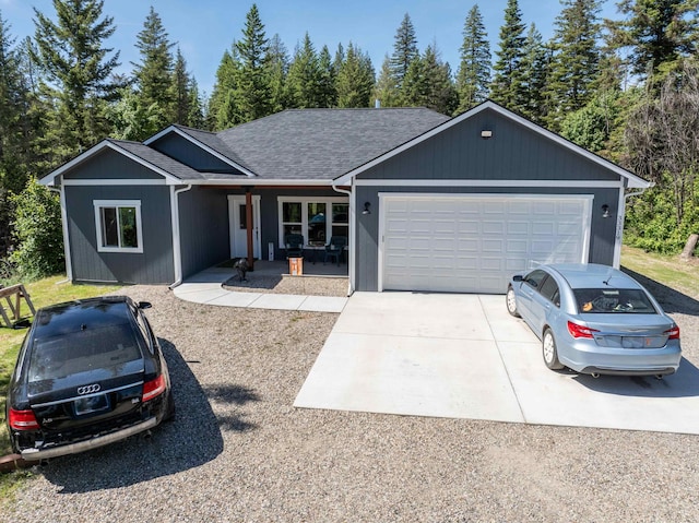 33319 N Conklin Rd, Elk, WA 99009 - single story home featuring driveway, a garage, a porch, and a shingled roof