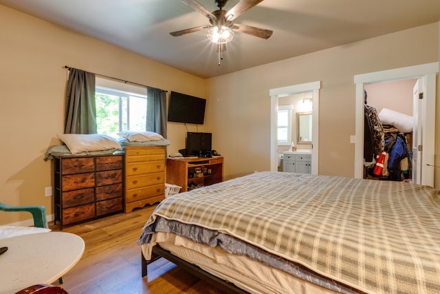 33319 N Conklin Rd, Elk, WA 99009 - bedroom with wood finished floors, a spacious closet, a closet, ensuite bath, and ceiling fan