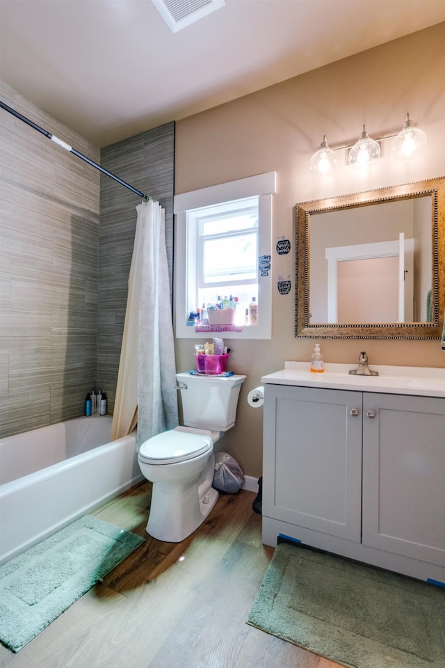 33319 N Conklin Rd, Elk, WA 99009 - full bathroom with toilet, wood finished floors, vanity, and shower / bathtub combination with curtain