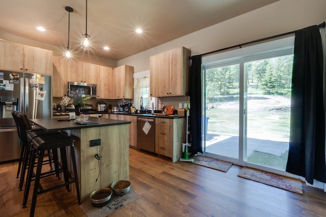 33319 N Conklin Rd, Elk, WA 99009 - kitchen featuring appliances with stainless steel finishes, light brown cabinetry, dark countertops, a breakfast bar area, and recessed lighting