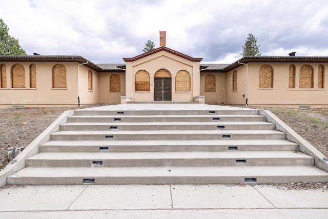 2225 S Inland Empire Way, Spokane, WA 99224 - view of front of property with stairway, stucco siding, and a chimney