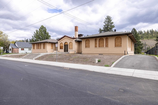 2225 S Inland Empire Way, Spokane, WA 99224 - mediterranean / spanish-style home with stucco siding, a chimney, and driveway