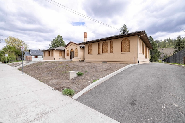 2225 S Inland Empire Way, Spokane, WA 99224 - mediterranean / spanish-style house featuring stucco siding and a chimney