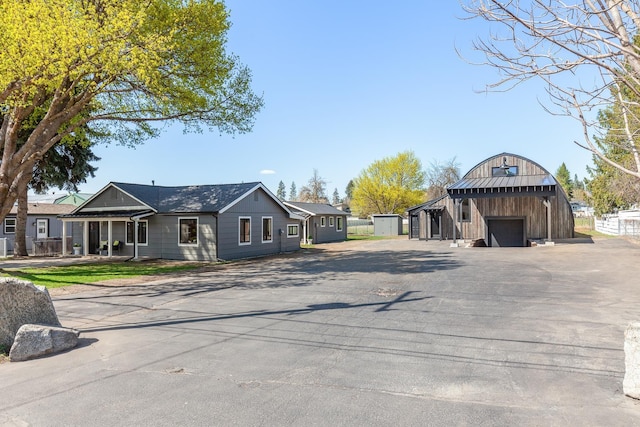 1431 E Miles Ave, Hayden, ID 83835 - view of front of home featuring a detached garage, an outdoor structure, and asphalt driveway